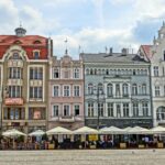 Vista panoramica di una città europea con piatti tipici e ristoranti affollati.